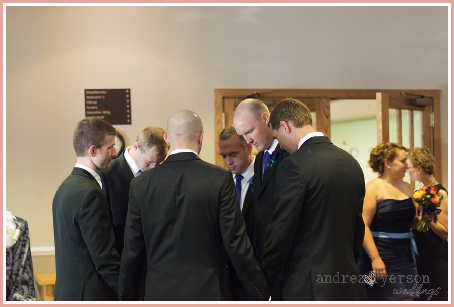 groom and groomsmen saying a prayer Brookfield Wisconsin wedding
