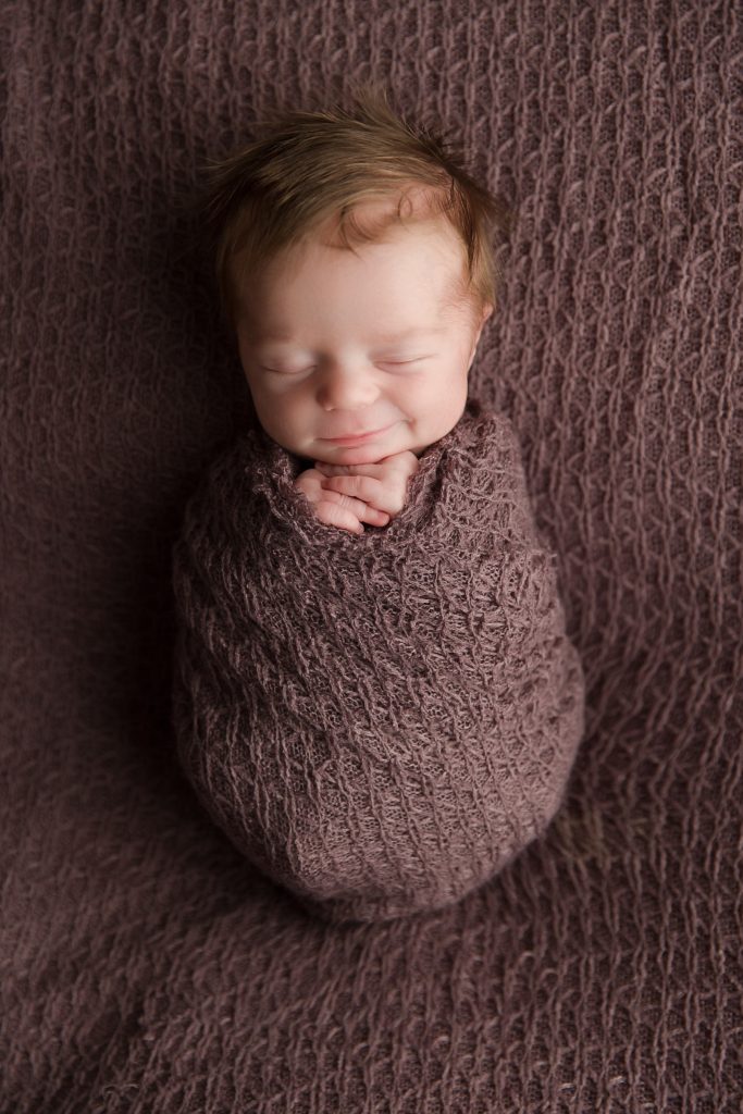 happy newborn photographer